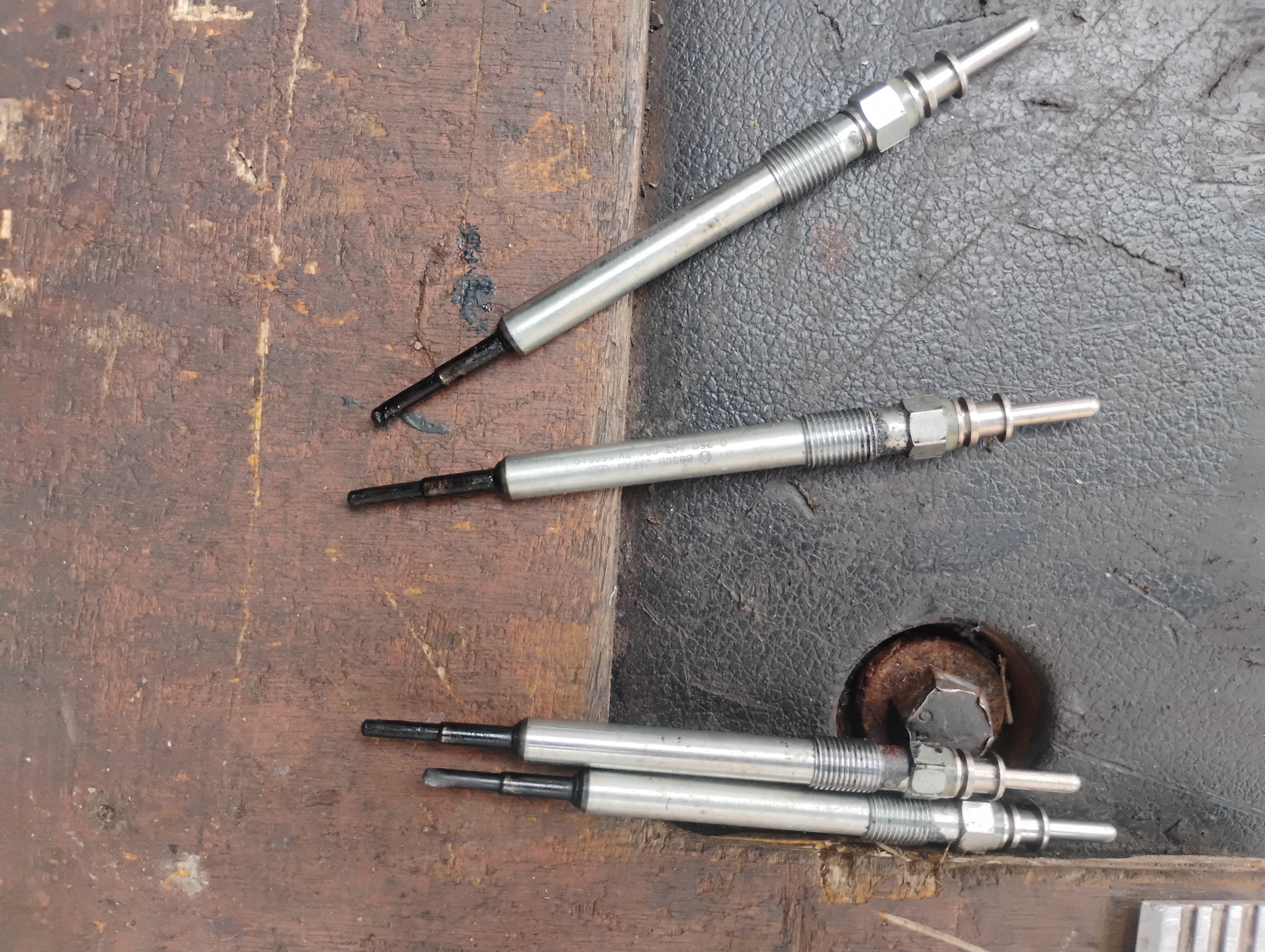 Oily glow plugs removed during repair work